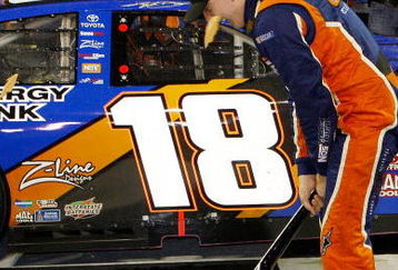 NASHVILLE, TN - JUNE 06:  Kyle Busch, driver of the #18 NOS Energy Drink Toyota celebrates by smashing the Gibson Guitar given to the winner after winning the NASCAR Nationwide Series Federated Auto Parts 300 at the Nashville Superspeedway on June 6, 2009 in Lebanon,Tennessee.  (Photo by Chris Graythen/Getty Images for NASCAR)