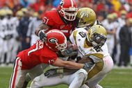 ATHENS, GA - NOVEMBER 29:  Defensive teammates Chad Gloer #17 and Akeem Dent #51 of the Georgia Bulldogs tackle running back Roddy Jones #20 of the Georgia Tech Yellow Jackets while Jones' teammate Marcus Wright #3 tries to block during the game at Sanford Stadium on November 29, 2008 in Athens, Georgia.  The Yellow Jackets defeated the Bulldogs 45-42.  (Photo by Mike Zarrilli/Getty Images)