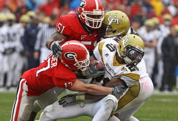 ATHENS, GA - NOVEMBER 29:  Defensive teammates Chad Gloer #17 and Akeem Dent #51 of the Georgia Bulldogs tackle running back Roddy Jones #20 of the Georgia Tech Yellow Jackets while Jones' teammate Marcus Wright #3 tries to block during the game at Sanford Stadium on November 29, 2008 in Athens, Georgia.  The Yellow Jackets defeated the Bulldogs 45-42.  (Photo by Mike Zarrilli/Getty Images)