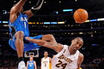 LOS ANGELES, CA - JUNE 07:  Dwight Howard #12 of the Orlando Magic dunks the ball over Kobe Bryant #24 of the Los Angeles Lakers in Game Two of the 2009 NBA Finals at Staples Center on June 7, 2009 in Los Angeles, California. NOTE TO USER: User expressly acknowledges and agrees that, by downloading and or using this photograph, User is consenting to the terms and conditions of the Getty Images License Agreement.  (Photo by Mark J. Terrill-Pool/Getty Images)
