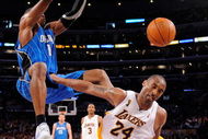 LOS ANGELES, CA - JUNE 07: Dwight Howard #12 of the Orlando Magic dunks the ball over Kobe Bryant #24 of the Los Angeles Lakers in Game Two of the 2009 NBA Finals at Staples Center on June 7, 2009 in Los Angeles, California. NOTE TO USER: User expressly acknowledges and agrees that, by downloading and or using this photograph, User is consenting to the terms and conditions of the Getty Images License Agreement. (Photo by Mark J. Terrill-Pool/Getty Images)