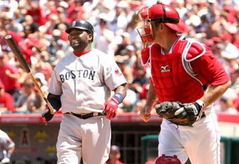 ANAHEIM, CA - MAY 14:  David Ortiz #34 of the Boston Red Sox reacts after striking out swinging with the bases loaded to end the fourth inning as catcher Jeff Mathis #5 of the Los Angeles Angels of Anaheim returns to the dugout on May 14, 2009 at Angel Stadium in Anaheim, California.  The Angels won 5-4 in 12 innings.  (Photo by Stephen Dunn/Getty Images)