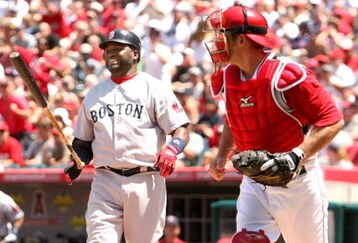 ANAHEIM, CA - MAY 14:  David Ortiz #34 of the Boston Red Sox reacts after striking out swinging with the bases loaded to end the fourth inning as catcher Jeff Mathis #5 of the Los Angeles Angels of Anaheim returns to the dugout on May 14, 2009 at Angel Stadium in Anaheim, California.  The Angels won 5-4 in 12 innings.  (Photo by Stephen Dunn/Getty Images)