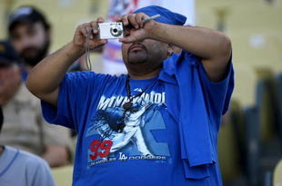 LOS ANGELES - MAY 7:  A fan wearing a Manny Ramirez tee shirt for takes a picture during pregame before the game between the Los Angeles Dodgers and the Washington Nationals on May 7, 2009 at Dodger Stadiium in Los Angeles, California.    (Photo by Stephen Dunn/Getty Images)