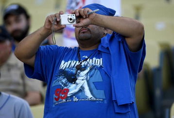 LOS ANGELES - MAY 7:  A fan wearing a Manny Ramirez tee shirt for takes a picture during pregame before the game between the Los Angeles Dodgers and the Washington Nationals on May 7, 2009 at Dodger Stadiium in Los Angeles, California.    (Photo by Stephen Dunn/Getty Images)