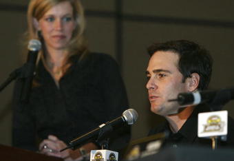 MIAMI - NOVEMBER 16: Moderator Krista Voda of Speed watches chase Jimmie Johnson, driver of the #48 Lowe's Chevrolet as he speaks with reporters during the NASCAR Nextel Cup Chase Contenders Press Conference at the Doral Golf Resort & Spa on November 16, 2006 in Miami, Florida.  (Photo by Doug Benc/Getty Images)