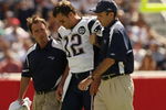 FOXBORO, MA - SEPTEMBER 7:  Quarterback Tom Brady #12 of the New England Patriots is helped off the field by trainers after he sustained an injury to his left knee in the first quarter against the Kansas City Chiefs at Gillette Stadium September 7, 2008 in Foxboro, Massachusetts.  (Photo by Elsa/Getty Images)