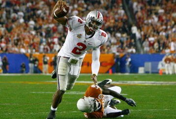 GLENDALE, AZ - JANUARY 05:  Quarterback Terrelle Pryor #2 of the Ohio State Buckeyes scrambles with the ball under pressure from Ryan Palmer #13 of the Texas Longhorns during the Tostitos Fiesta Bowl Game on January 5, 2009 at University of Phoenix Stadium in Glendale, Arizona.  (Photo by Jeff Gross/Getty Images)