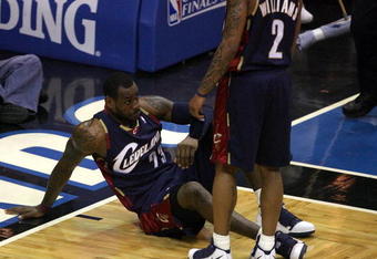 ORLANDO, FL - MAY 30: LeBron James #23 of the Cleveland Cavaliers sits on the court after being fouled by the Orlando Magic in Game Six of the Eastern Conference Finals during the 2009 Playoffs at Amway Arena on May 30, 2009 in Orlando, Florida. NOTE TO USER: User expressly acknowledges and agrees that, by downloading and or using this photograph, User is consenting to the terms and conditions of the Getty Images License Agreement  (Photo by Doug Benc/Getty Images)