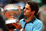 PARIS - JUNE 07:  Roger Federer of Switzerland poses with the trophy as he celebrates victory during the Men's Singles Final match against Robin Soderling of Sweden on day fifteen of the French Open at Roland Garros on June 7, 2009 in Paris, France.  (Photo by Clive Brunskill/Getty Images)