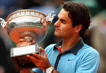 PARIS - JUNE 07:  Roger Federer of Switzerland poses with the trophy as he celebrates victory during the Men's Singles Final match against Robin Soderling of Sweden on day fifteen of the French Open at Roland Garros on June 7, 2009 in Paris, France.  (Photo by Clive Brunskill/Getty Images)