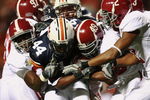 AUBURN, AL - NOVEMBER 24:  Running back Ben Tate #44 of the Auburn Tigers drags a group of Alabama Crimson Tide defenders at Jordan-Hare Stadium on November 24, 2007 in Auburn, Alabama.   (Photo by Doug Benc/Getty Images)