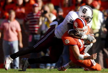 CLEMSON, SC - NOVEMBER 25:  Jasper Brinkley #52 of the South Carolina Gamecocks sacks quarterback Will Proctor #14 of the Clemson Tigers during an NCAA football game at Memorial Stadium November 25, 2006 in Clemson, South Carolina. South Carolina won 31-28.  (Photo by Grant Halverson/Getty Images)