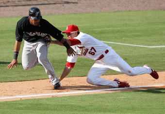 JUPITER, FL - FEBRUARY 25:  Third baseman Tyler Greene #67 of the St. Louis Cardinals tags out Robert Andino #11 of the Florida Marlins after being caught in a rundown in the ninth inning during a spring training game at Roger Dean Stadium on February 25, 2009 in Jupiter, Florida.  (Photo by Doug Benc/Getty Images)