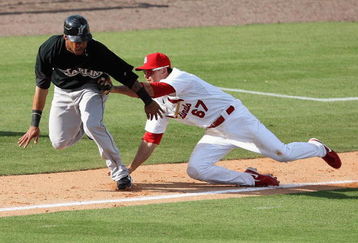JUPITER, FL - FEBRUARY 25:  Third baseman Tyler Greene #67 of the St. Louis Cardinals tags out Robert Andino #11 of the Florida Marlins after being caught in a rundown in the ninth inning during a spring training game at Roger Dean Stadium on February 25, 2009 in Jupiter, Florida.  (Photo by Doug Benc/Getty Images)
