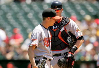 OAKLAND, CA - JUNE 07:  Starting pitcher Rich Hill #51 of the Baltimore Orioles talks with catcher Matt Wieters #15 in the first inning of their game against the Oakland Athletics at the Oakland Coliseum on June 7, 2009 in Oakland, California.  Hill gave up four walks and hit one batter before being removed in the first inning. (Photo by Ezra Shaw/Getty Images)