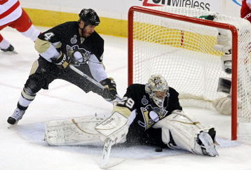PITTSBURGH - JUNE 09:  Goaltender Marc-Andre Fleury #29 of the Pittsburgh Penguins saves a shot on goal by the Detroit Red Wings as Rob Scuderi #4 looks on during Game Six of the NHL Stanley Cup Finals at the Mellon Arena on June 9, 2009 in Pittsburgh, Pennsylvania.  (Photo by Bruce Bennett/Getty Images)