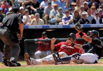 DENVER - MAY 14:  Carlos Lee #45 of the Houston Astros is called out by homeplate umpire Charlie Redford as he slides into home and is tagged out by catcher Yorvit Torrealba #8 of the Colorado Rockies as Lee tried to score on a double by Hunter Pence in the third inning during MLB action at Coors Field on May 14, 2009 in Denver, Colorado.  (Photo by Doug Pensinger/Getty Images)