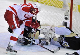 PITTSBURGH - JUNE 09:  Rob Scuderi #4 and goaltender Marc-Andre Fleury #29 of the Pittsburgh Penguins defends the net against Johan Franzen #93 of the Detroit Red Wings during Game Six of the NHL Stanley Cup Finals at the Mellon Arena on June 9, 2009 in Pittsburgh, Pennsylvania.  (Photo by Jamie Sabau/Getty Images)