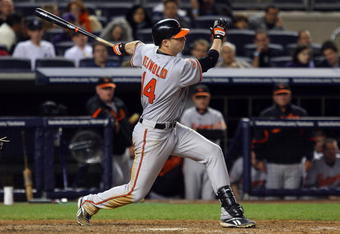 NEW YORK - MAY 19:  Nolan Reimold #14 of the Baltimore Orioles bats against the New York Yankees on May 19, 2009 at Yankee Stadium in the Bronx borough of New York City.  (Photo by Jim McIsaac/Getty Images)