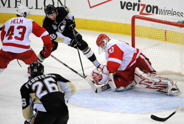 PITTSBURGH - JUNE 09:  Tyler Kennedy #48 of the Pittsburgh Penguins shoots a goal past goaltender Chris Osgood #30 of the Detroit Red Wings during Game Six of the NHL Stanley Cup Finals at the Mellon Arena on June 9, 2009 in Pittsburgh, Pennsylvania.  (Photo by Harry How/Getty Images)