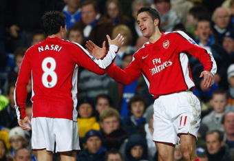 LONDON - NOVEMBER 30:  Robin Van Persie of Arsenal is congratulated by teammate Samir Nasre after scoring his team's second goal during the Barclays Premier League match between Chelsea and Arsenal at Stamford Bridge on November 30, 2008 in London, England.  (Photo by Clive Mason/Getty Images)