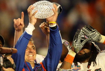 MIAMI - JANUARY 08:  Head coach Urban Meyer of the Florida Gators celebrates with the National Championship trophy after therir 24-14 win against the Oklahoma Sooners during the FedEx BCS National Championship game at Dolphin Stadium on January 8, 2009 in Miami, Florida.  (Photo by Doug Benc/Getty Images)