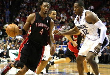 ORLANDO, FL - NOVEMBER 18: Chris Bosh #4 of the Toronto Raptors drives against Dwight Howard #12 of the Orlando Magic during the game on November 18, 2008 at Amway Arena in Orlando, Florida.  NOTE TO USER: User expressly acknowledges and agrees that, by downloading and/or using this Photograph, user is consenting to the terms and conditions of the Getty Images License Agreement.  (Photo by Sam Greenwood/Getty Images)