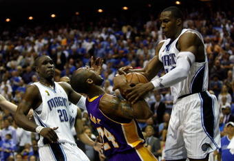 ORLANDO, FL - JUNE 09:  Kobe Bryant #24 of the Los Angeles Lakers goes up for a shot against Dwight Howard #12 of the Orlando Magic as Howard was called for a foul in Game Three of the 2009 NBA Finals on June 9, 2009 at Amway Arena in Orlando, Florida.  NOTE TO USER:  User expressly acknowledges and agrees that, by downloading and or using this photograph, User is consenting to the terms and conditions of the Getty Images License Agreement.  (Photo by Chris Graythen/Getty Images)