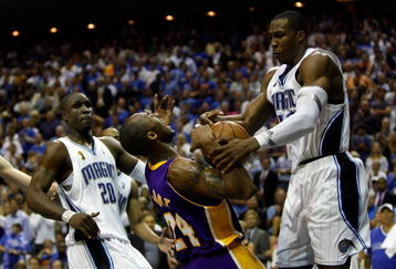 ORLANDO, FL - JUNE 09:  Kobe Bryant #24 of the Los Angeles Lakers goes up for a shot against Dwight Howard #12 of the Orlando Magic as Howard was called for a foul in Game Three of the 2009 NBA Finals on June 9, 2009 at Amway Arena in Orlando, Florida.  NOTE TO USER:  User expressly acknowledges and agrees that, by downloading and or using this photograph, User is consenting to the terms and conditions of the Getty Images License Agreement.  (Photo by Chris Graythen/Getty Images)