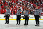 DETROIT - MAY 31:  (L-R) Linesman Steve Miller, referees Marc Joannette and Bill McCreary, and linesman Jean Morin line up for the national anthem prior to the Pittsburgh Penguins playing the Detroit Red Wings during Game Two of the 2009 Stanley Cup Finals at Joe Louis Arena on May 31, 2009 in Detroit, Michigan.  (Photo by Jim McIsaac/Getty Images)
