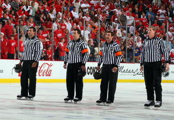 DETROIT - MAY 31:  (L-R) Linesman Steve Miller, referees Marc Joannette and Bill McCreary, and linesman Jean Morin line up for the national anthem prior to the Pittsburgh Penguins playing the Detroit Red Wings during Game Two of the 2009 Stanley Cup Finals at Joe Louis Arena on May 31, 2009 in Detroit, Michigan.  (Photo by Jim McIsaac/Getty Images)