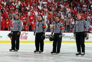 DETROIT - MAY 31:  (L-R) Linesman Steve Miller, referees Marc Joannette and Bill McCreary, and linesman Jean Morin line up for the national anthem prior to the Pittsburgh Penguins playing the Detroit Red Wings during Game Two of the 2009 Stanley Cup Finals at Joe Louis Arena on May 31, 2009 in Detroit, Michigan.  (Photo by Jim McIsaac/Getty Images)