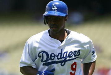 LOS ANGELES, CA - JUNE 06:  Juan Pierre #9 of the Los Angeles Dodgers runs back to the dugout against the Philadelphia Phillies at Dodger Stadium on June 6, 2009 in Los Angeles, California. The Dodgers defeated the Phillies 3-2 in 12 innings.  (Photo by Jeff Gross/Getty Images)