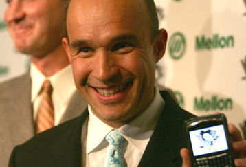 PITTSBURGH - OCTOBER 05:  Jim Balsillie Chairman and Co-CEO of Research In Motion and new owner of the Pittsburgh Penguins poses with his Blackberry in a press conference announcing the purchase of the team alongside Mario Lemieux after the first period at Mellon Arena on October 5, 2006 in Pittsburgh, Pennsylvania.  (Photo by Harry How/Getty Images) 