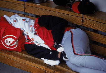 24 May 2001:  Rubin Rivera #28 of the Cincinnati Reds takes a nap during the rain delay of the game against the Chicago Cubs at Wrigley Field in Chicago, Illinois. The Cubs defeated the Reds 3-0.Mandatory Credit: Jonathan Daniel  /Allsport