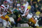EUGENE, OR - OCTOBER 27:  Quarterback Dennis Dixon #10 of the Oregon Ducks is hit by Brian Crushing #10 of the Southern California Trojans at Autzen Stadium October 27, 2007 in Eugene, Oregon.  (Photo by Jonathan Ferrey/Getty Images)