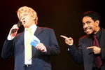 SYDNEY, AUSTRALIA - APRIL 21:  Actor David Wenham who plays Jerry Springer welcomes viewers to the show as  actor David Bedella, who plays the warm-up man gestures toward him during the 'Jerry Springer: The Opera' photocall at the Sydney Opera House in Sydney, Australia.  (Photo by Mark Kolbe/Getty Images)