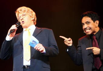 SYDNEY, AUSTRALIA - APRIL 21:  Actor David Wenham who plays Jerry Springer welcomes viewers to the show as  actor David Bedella, who plays the warm-up man gestures toward him during the 'Jerry Springer: The Opera' photocall at the Sydney Opera House in Sydney, Australia.  (Photo by Mark Kolbe/Getty Images)