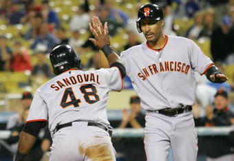 LOS ANGELES, CA - SEPTEMBER 19:  (L-R) Pablo Sandoval #48 and teammate Randy Winn #2 of the San Francisco Giants celebrate after scoring in the first inning against the Los Angeles Dodgers at Dodger Stadium on September 19, 2008 in Los Angeles, California.  (Photo by Lisa Blumenfeld/Getty Images)