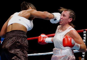BILOXI, MS - AUGUST 23:  Laila Ali lands a punch on Christy Martin on August 23, 2003 at the Mississippi Coast Coliseum in Biloxi, Mississippi. Ali defeated Martin in the fourth round. (Photo by Chris Graythen/Getty Images)