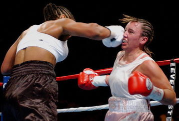 BILOXI, MS - AUGUST 23:  Laila Ali lands a punch on Christy Martin on August 23, 2003 at the Mississippi Coast Coliseum in Biloxi, Mississippi. Ali defeated Martin in the fourth round. (Photo by Chris Graythen/Getty Images)