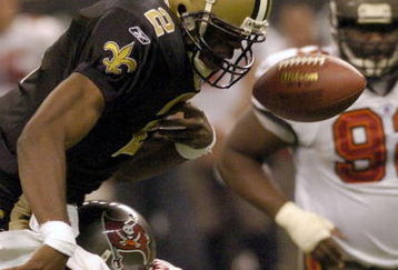 NEW ORLEANS, LA - DECEMBER 7:  Aaron Brooks #2 of the New Orleans Saints fumbles the ball as he is tackled by Derrick Brooks #55 of the Tampa Bay Buccaneers on December 7, 2003 at the Superdome in New Orleans, Louisiana.  (Photo by Chris Graythen/Getty Images)