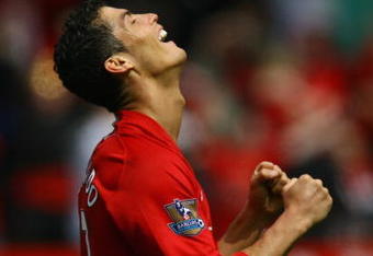 MANCHESTER, ENGLAND - MAY 16:  Cristiano Ronaldo of Manchester United celebrates as the final whistle is blown and his side clinch the Premier League title at the end of the Barclays Premier League match between Manchester United and Arsenal at Old Trafford on May 16, 2009 in Manchester, England.  (Photo by Alex Livesey/Getty Images)