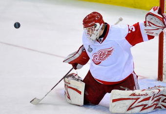 PITTSBURGH - JUNE 09:  Goaltender Chris Osgood #30 of the Detroit Red Wings saves a shot on goal by the Pittsburgh Penguins during Game Six of the NHL Stanley Cup Finals at the Mellon Arena on June 9, 2009 in Pittsburgh, Pennsylvania.  (Photo by Jamie Sabau/Getty Images)