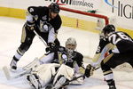 PITTSBURGH - JUNE 9:  Goaltender Marc-Andre Fleury #29 of the Pittsburgh Penguins makes a save against the Detroit Red Wings as Rob Scuderi #4 and Ruslan Fedotenko #26 help out during Game Six of the 2009 NHL Stanley Cup Finals at the Mellon Arena on June 9, 2009 in Pittsburgh, Pennsylvania. The Penguins defeated the Red Wings 2-1. (Photo by Bruce Bennett/Getty Images)