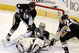 PITTSBURGH - JUNE 9: Goaltender Marc-Andre Fleury #29 of the Pittsburgh Penguins makes a save against the Detroit Red Wings as Rob Scuderi #4 and Ruslan Fedotenko #26 help out during Game Six of the 2009 NHL Stanley Cup Finals at the Mellon Arena on June 9, 2009 in Pittsburgh, Pennsylvania. The Penguins defeated the Red Wings 2-1. (Photo by Bruce Bennett/Getty Images)