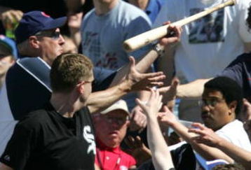 CHICAGO - MAY 22:  Fans reach for a bat that slipped out of the hands of Jeromy Burnitz of the Chicago Cubs and flew into the stands during a game against the Chicago White Sox on May 22, 2005 at Wrigley Field in Chicago, Illinois. The Cubs defeated the White Sox 4-3.  (Photo by Jonathan Daniel/Getty Images)
