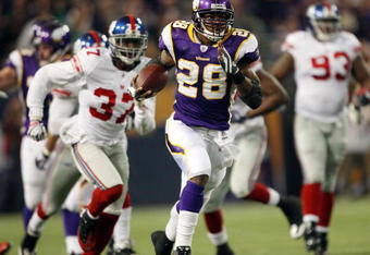 MINNEAPOLIS - DECEMBER 28:   Adrian Peterson #28 of the Minnesota Vikings runs the ball in for a touchdown as James Butler of the New York Giants defends on December 28, 2008 at the Hubert H. Humphrey Metrodome in Minneapolis, Minnesota. The Vikings defeated the Giants 20-19. (Photo by Elsa/Getty Images)