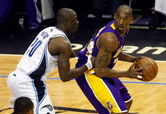 ORLANDO, FL - JUNE 11:  Kobe Bryant #24 of the Los Angeles Lakers posts up Mickael Pietrus #20 of the Orlando Magic in the first quarter of Game Four of the 2009 NBA Finals on June 11, 2009 at Amway Arena in Orlando, Florida.  NOTE TO USER:  User expressly acknowledges and agrees that, by downloading and or using this photograph, User is consenting to the terms and conditions of the Getty Images License Agreement.  (Photo by Ronald Martinez/Getty Images)
